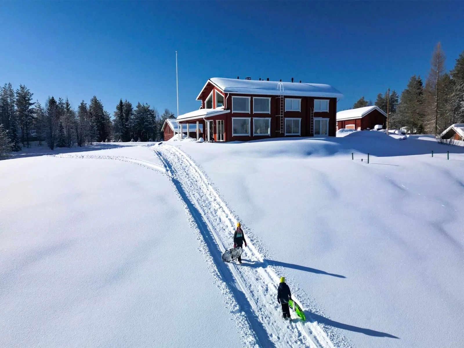 Skiers on the track below Villa Lehtoniemi