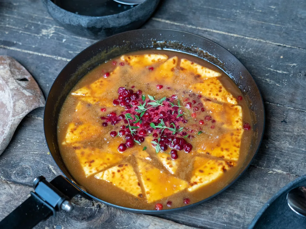 A golden pan preparation finished with lingonberries and herbs